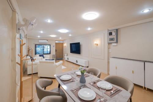 a dining room and living room with a table and chairs at Baan Sukhumvit 101 in Phra Khanong