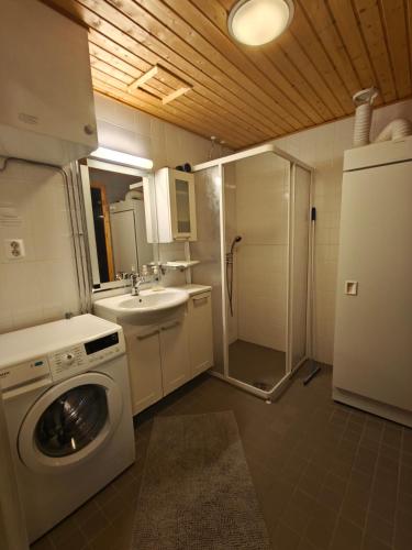 a bathroom with a washing machine and a sink at Chalet Ylläs C413 included bed linen and towels in Ylläs