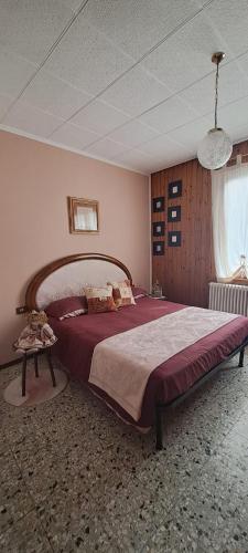 a bedroom with a large bed in a room at La casetta di Marilena in Bindo