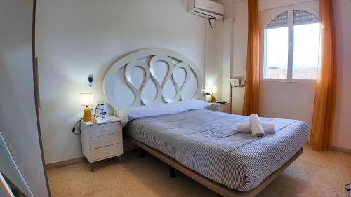 a bedroom with a large bed with a large headboard at Apartalux Cielo Dorado in San Juan de los Terreros