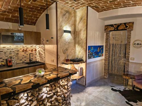 a kitchen with a stone counter and a sink at Suite Mediterraneo in Civitavecchia