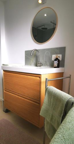 a bathroom with a sink and a mirror at La Maison Trente in Chooz