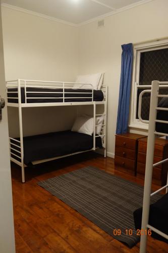 a bedroom with two bunk beds and a window at Morella Farmstay in Cape Jervis