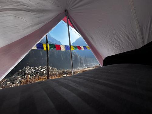 a view from the inside of a tent with flags at Kasol Shalom Camps & Cafe in Kasol