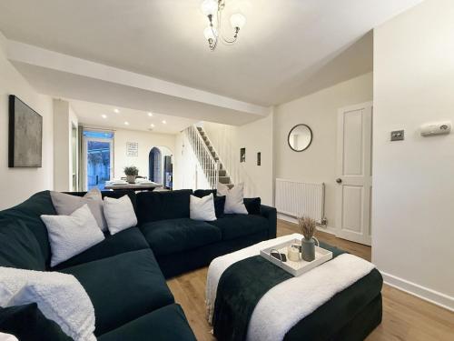 a living room with a couch and a table at 2 bed house secure parking Sleeps 6 in Ipswich
