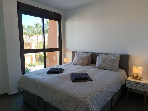 a bedroom with a large bed with a large window at Royal Park Green Spa in Orihuela Costa