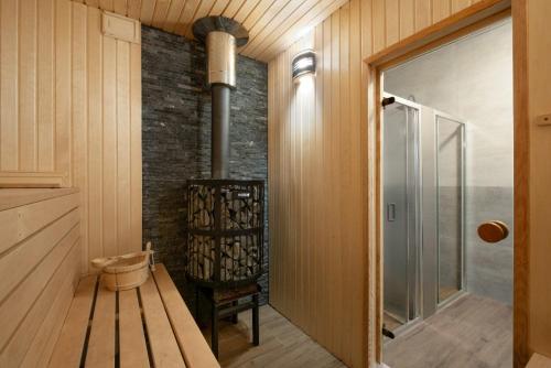 a room with a wood stove and a bench at Chalupa u Rašovských in Jasenice