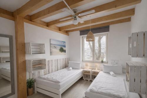 a room with two beds and a window at Hamburg Sleep Club in Hamburg