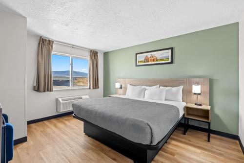 a hotel room with a bed and a window at Quality Inn Beaver I-15 in Beaver