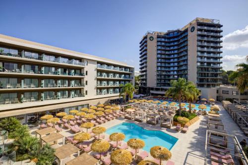 an aerial view of a hotel with a pool and chairs at Aubamar Palma Resort in Playa de Palma