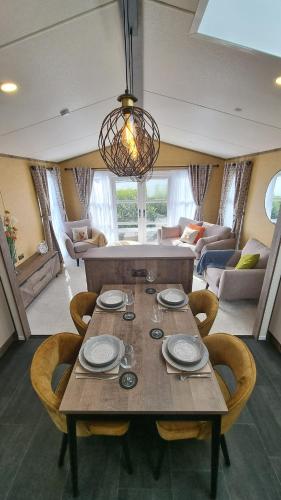 a dining table and chairs in a living room at 1 Sunset View in Millom