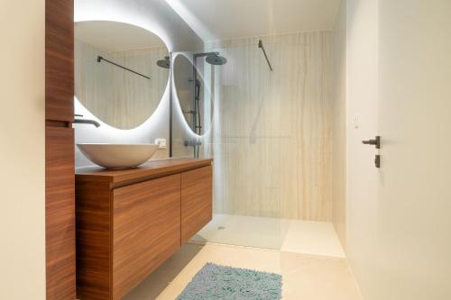 a bathroom with a sink and a mirror at Oase 41 - 5 STAR location with Indoor swimming pool & unique landscape view in Sint-Laureins