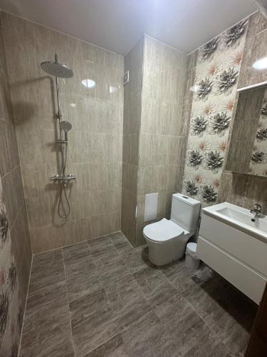 a bathroom with a shower and a toilet and a sink at Le Bijou МОЛ Плаза in Plovdiv