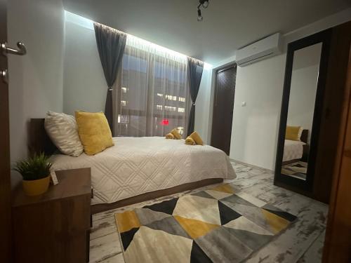 a bedroom with a bed and a large mirror at Le Bijou МОЛ Плаза in Plovdiv