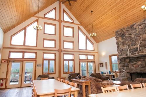 a large living room with a large stone fireplace at Homestake Lodge in Whitehall