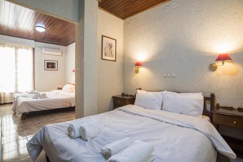 a hotel room with two beds with towels on them at Hotel Villa Apollonia Delphi in Delphi