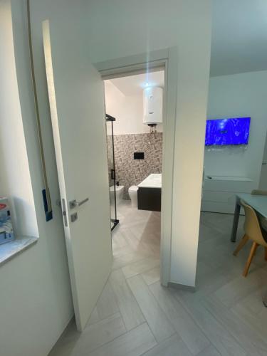 a door leading into a room with a bathroom at OLYMPO HOUSE senza balcone in Agrigento