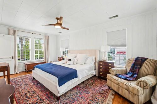 a bedroom with a bed and a couch and a chair at Beaufort 308 Charles in Beaufort