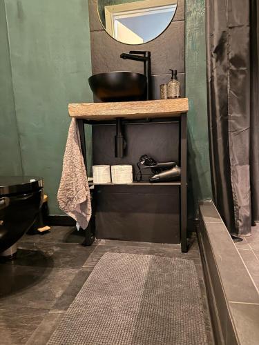 a bathroom with a counter with a sink and a mirror at Design Apartment in Plettenberg