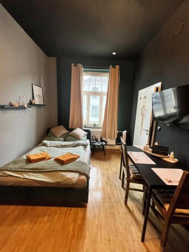 a bedroom with a bed and a desk and a table at Design Apartment in Plettenberg