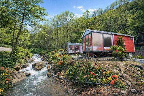 a tiny house on the side of a stream at Eça River Bungalov in Ayder Yaylasi