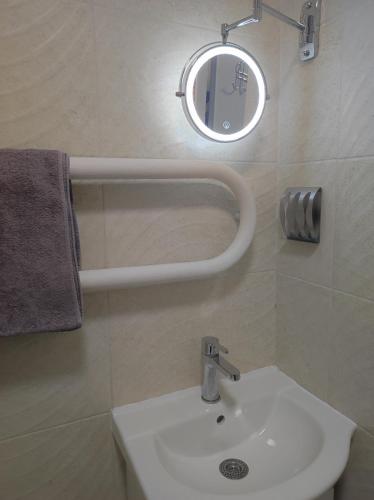 a bathroom with a white sink and a mirror at Laima in Riga