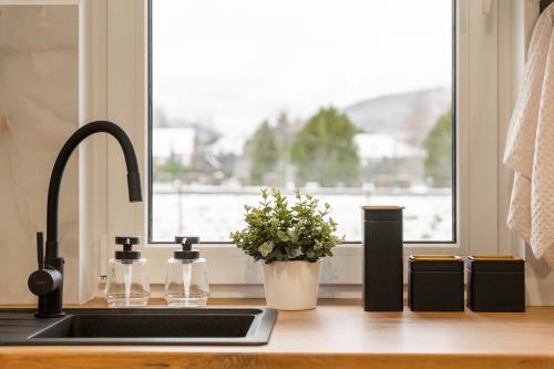 a kitchen counter with a sink and a window at Domek Wierzbowa 5 in Brenna