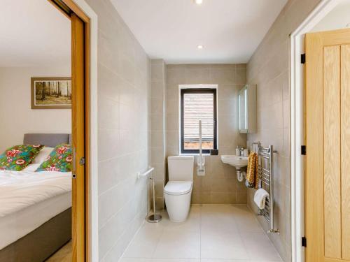 a bathroom with a toilet and a bed and a sink at 2 Bed in Alcester oc-88397 in Coughton