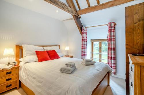 a bedroom with a large bed with red pillows at 2 Bed in Govilon oc-u32754 in Govilon