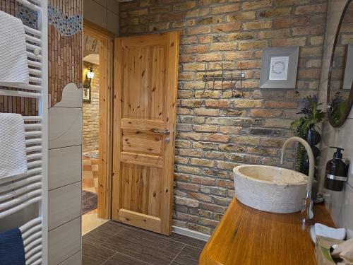 a bathroom with a sink and a brick wall at Altstadt Speyer in Speyer