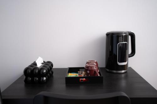 a black table with a coffee maker and a box at Hôtel Sofiane in Paris