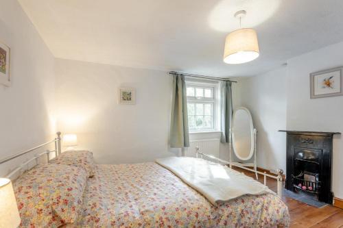 a bedroom with a bed and a mirror at 2 Bed in Beccles oc-d33611 in Beccles