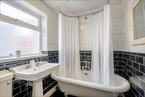 a bathroom with a sink and a tub and a shower at 2 Bed in Beccles oc-d33611 in Beccles