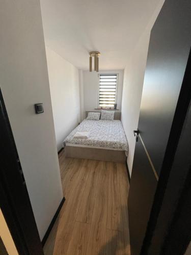 a small room with a bed and a window at CityView Tychy in Tychy