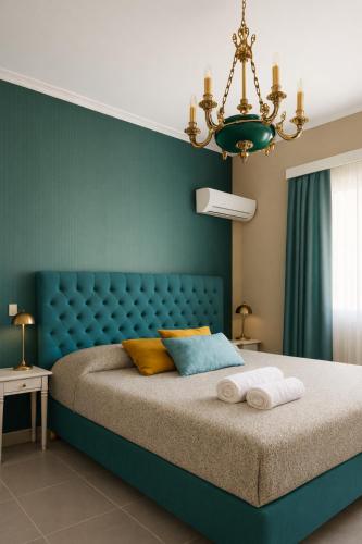 a bedroom with a blue bed with a blue headboard at Allegoria House in Nafplio