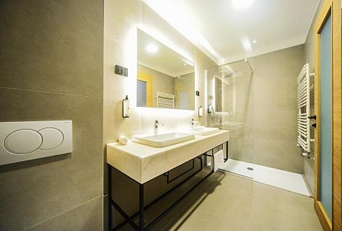 a bathroom with a sink and a mirror at Hotel Risnjak in Delnice