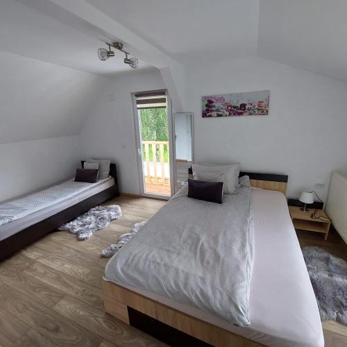 a bedroom with a large bed and a window at CABANA CASA LU'BACIU in Arpaşu de Sus