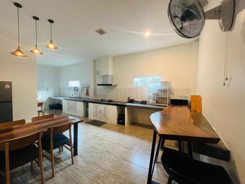 a large kitchen with a table and a fan at Modern Elephant Lagoon Villa in Ko Chang