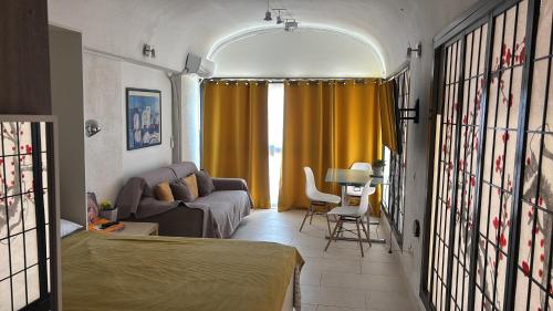 a living room with a couch and a table at Golfe de Saint Tropez Terrasses de Sylvabelle Gigaro in La Croix-Valmer