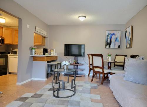 a living room with a couch and a table at Comfy 1BR Apartment - Ideal for Traveling Nurses & Professionals in Gainesville