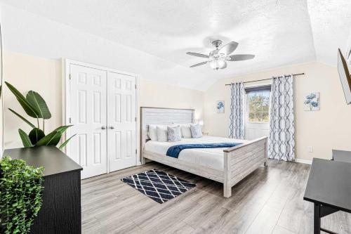 a bedroom with a bed and a ceiling fan at Cozy 2BR - Beach & Trail - Bikes, Fire Pit in St. Petersburg