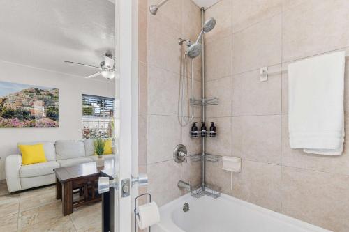 a bathroom with a bath tub and a couch at Cozy 2BR - Beach & Trail - Bikes, Fire Pit in St. Petersburg