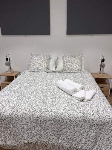 a bedroom with a bed with two towels on it at Las vegas in Alcorcón