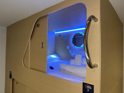 a room with a toilet with a blue light at Urban Cube Hostel Granada in Granada