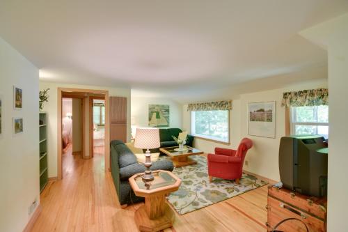 a living room with a couch and a tv at The Carriage House Walk to Peninsula State Park in Ephraim