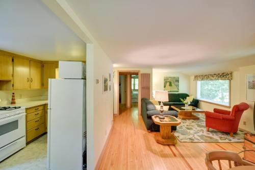 a kitchen and living room with a white refrigerator at The Carriage House Walk to Peninsula State Park in Ephraim