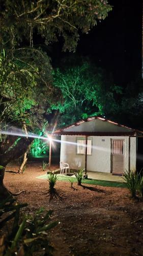 a small house with a light in front of it at Chalé Rústico Cumuruxatiba in Cumuruxatiba