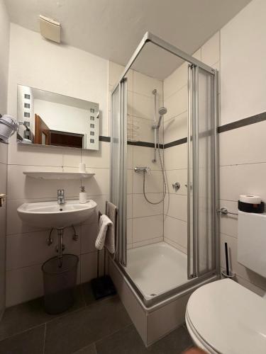 a bathroom with a shower and a sink at Gästehaus Margarita in Raubling