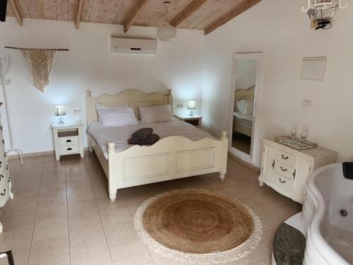 a bedroom with a bed and a sink and a mirror at Song of Galilee in Elifelet