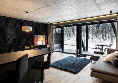a home office with a desk and a living room at JASNÁ Luxury Apartments with Mountain View in Belá